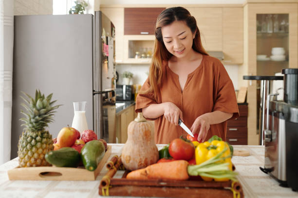 istock Young Woman Cooking Dinner 1329459145