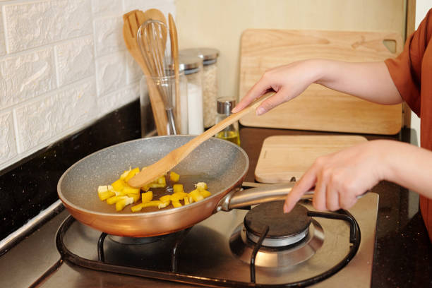 istock Housewife Frying Vegetables in Pan 1329459218