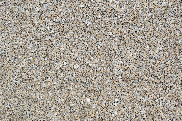 istock Dry white limestone ballast flat full frame background. Small gray dusty broken macadam stones texture. 1329459505