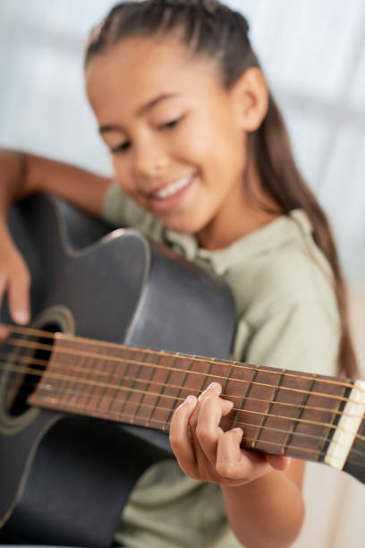 istock Girl learning to play guitar 1329461804