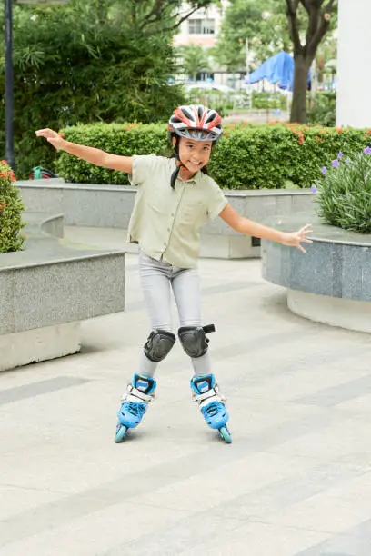 Photo of Little girl skating outdoors