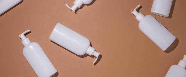 istock Dispenser bottles lie on a brown cardboard background. Top view, flat lay. Banner 1329462246