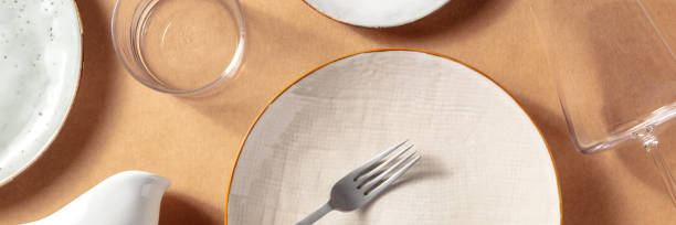 istock Tableware panorama with plates and glasses, shot from above 1329463289