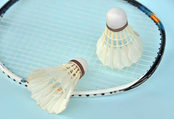 istock Badminton shuttelcock with racket as a background isolated on light blue color 1329463434