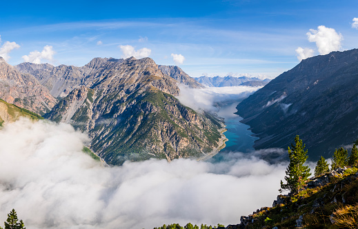 Lago del Gallo, or Lake of Livigno, as seen (or not seen) from above under the clouds (3 shots stitched)