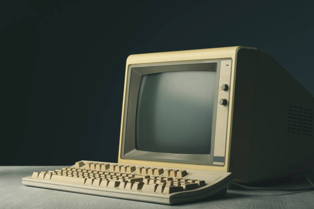 Vintage personal computer on a desktop Vintage personal computer with keyboard on a desktop, outdated electronics concept crt computer screen stock pictures, royalty-free photos & images