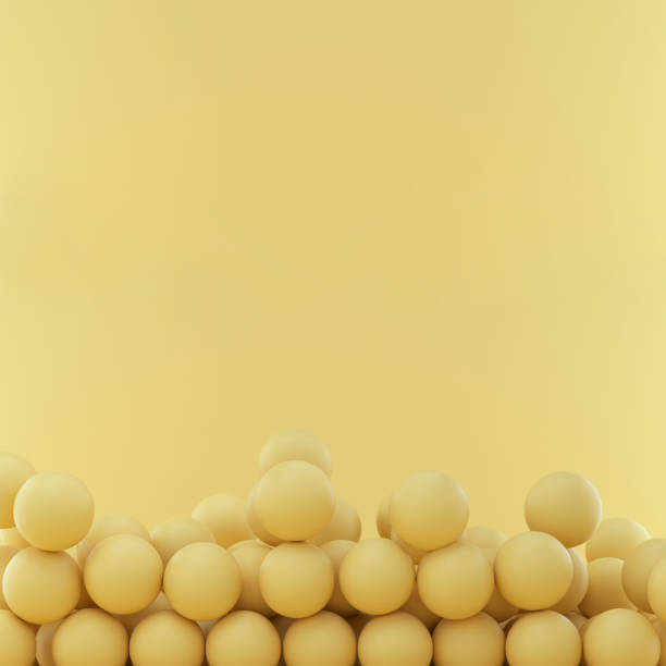 istock Spheres on yellow studio background with space for text or design. 1329466860