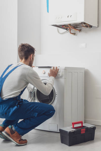 istock Repairman fixing a washing machine 1329466907