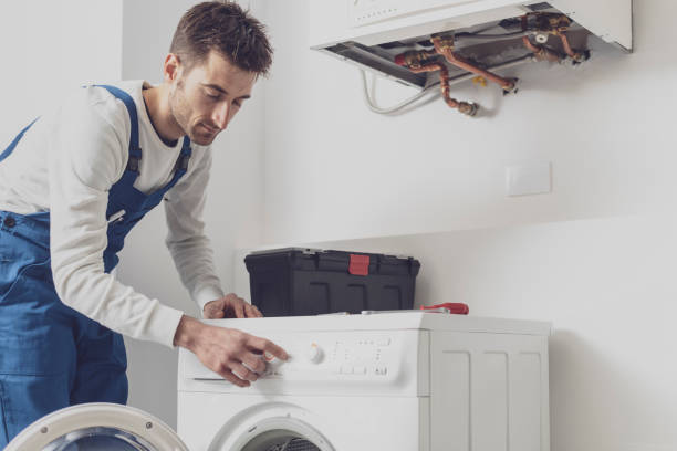 istock Professional repairman fixing a washing machine 1329466935