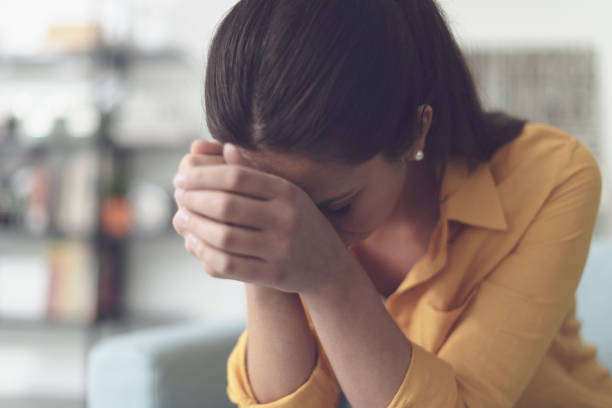 istock Depressed lonely woman sitting at home 1329467154