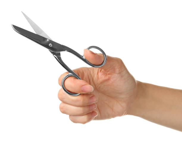 istock Woman holding sewing scissors isolated on white, closeup 1329468136