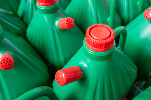 Green plastic bottles with non freezing cleaning liquid