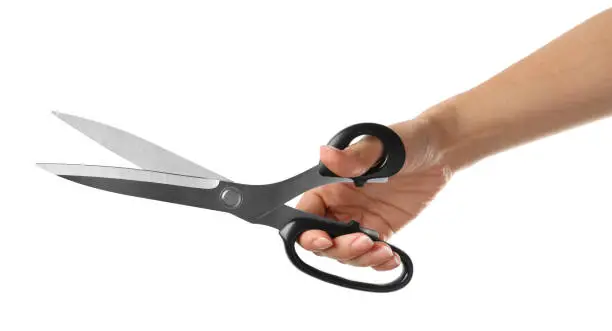 Photo of Woman holding tailor's scissors isolated on white, closeup