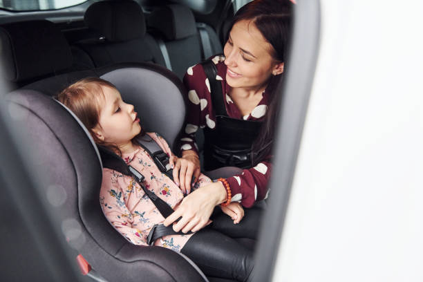 istock Mother with her daughter inside of modern automobile together 1329470574