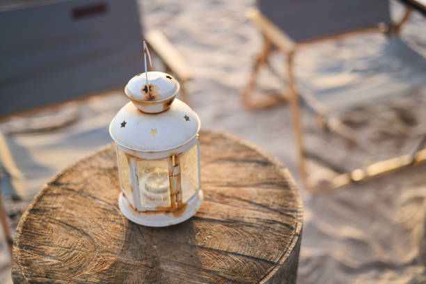 vintage lantern at the beach on a summer sunset, romantic concept image