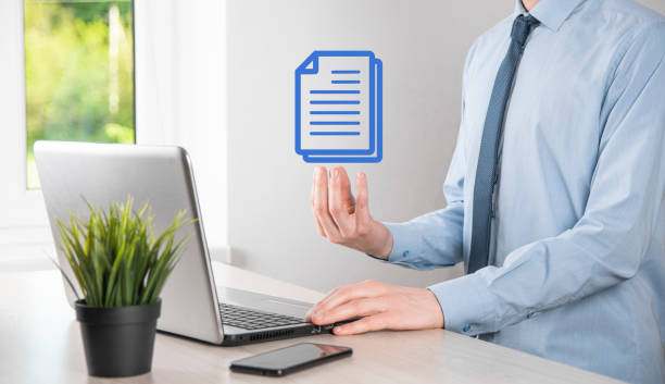 istock Businessman man holding a document icon in his hand Document Management Data System Business Internet Technology Concept. Corporate data management system DMS 1329474465