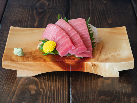 A sushi tray with fresh tuna sashimi.