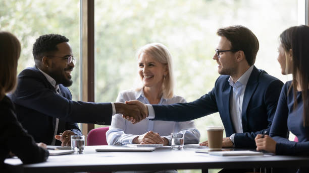 istock Happy multiethnic team members, conference participant, coworkers shaking hands 1329476173