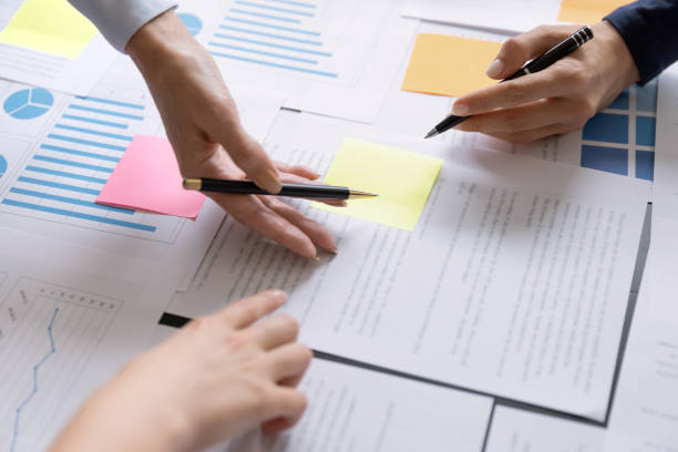 istock Business team of employees meeting, analyzing project document text 1329476185