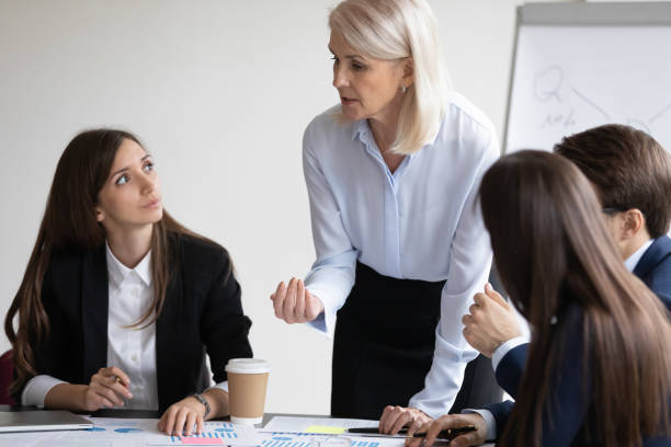 istock Confident senior business teacher training group of interns 1329476195