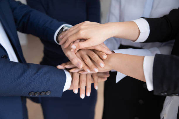 Team of office employees making community pile of hands gesture Business coworkers stacked hands close up. Team of office employees, workers making community pile of hands gesture, keeping teamwork, teambuilding, unity spirit, expressing engagement, respect office buddies stock pictures, royalty-free photos & images