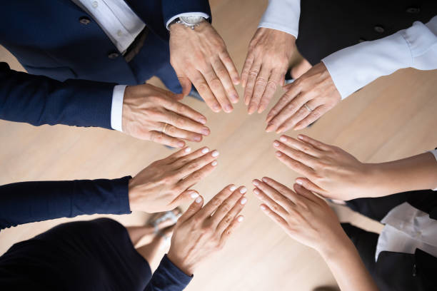 istock Different aged business team making circular shape of hands 1329476230