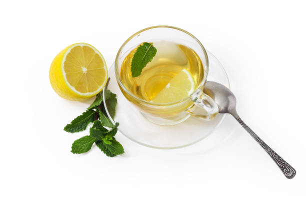 istock Tea with mint and lemon in glass cup on saucer 1329477939