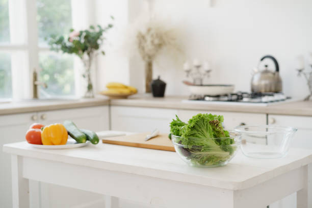 istock Fresh vegetables and lettuce on white wooden kitchen table 1329480560