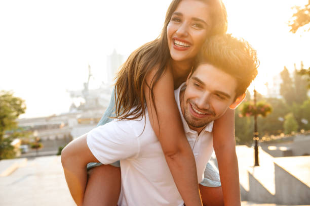 istock Happy young loving couple walking outdoors having fun. 1329482310