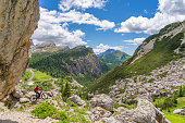 woman on electric mountain bike at Passo Falzarego, Dolomites Mountains, Italy