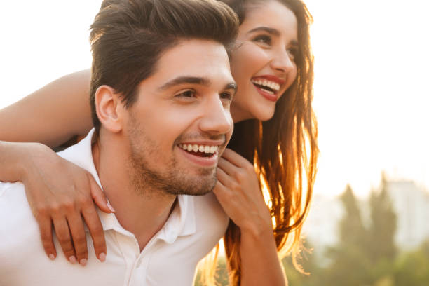 istock Happy young loving couple walking outdoors having fun. 1329483590