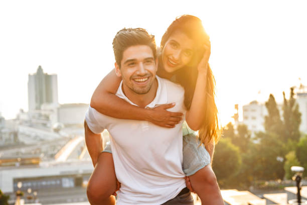 istock Happy young loving couple walking outdoors having fun. 1329483615