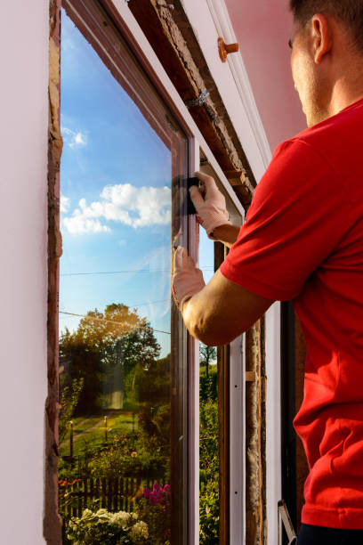 istock The worker inserts glass into the window frame, triple glazing of the plastic window, insulation and insulation. 1329484156