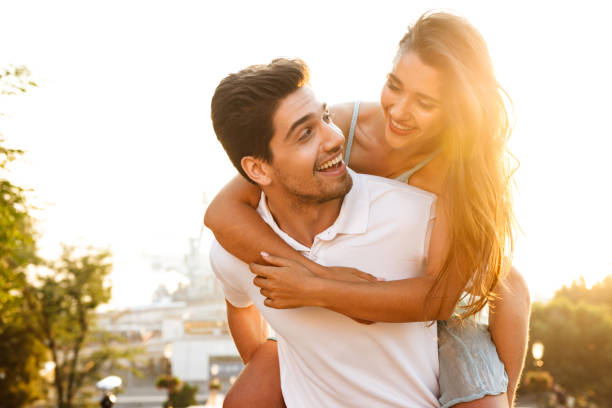 istock Happy young loving couple walking outdoors having fun. 1329484264