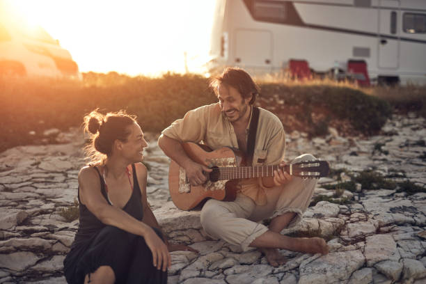 istock Man singing to his girlfriend on a beach. 1329484949
