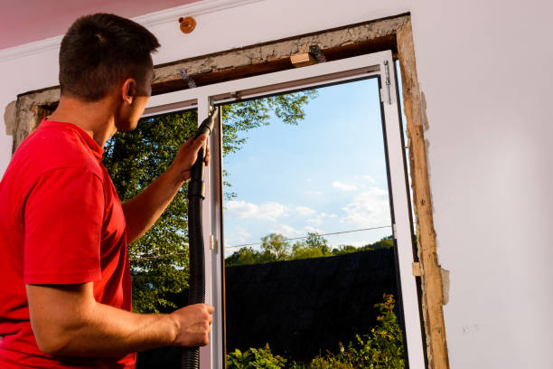 istock The man uses a vacuum cleaner to remove excess and left after disassembly and assembly dust and debris for further insulation of the window with foam. 1329485013