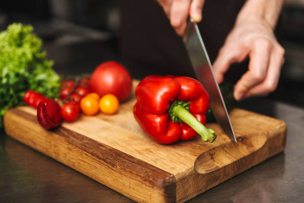 istock Close up of a man hands chopping vegetables 1329486925