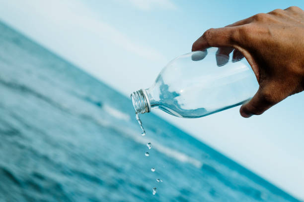 istock man emptying a glass reusable bottle 1329486962