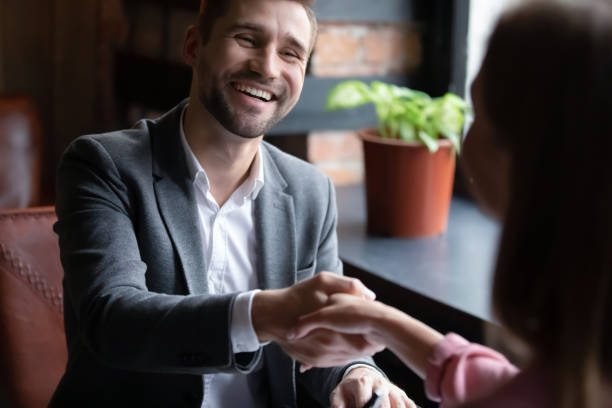 istock Happy young man shaking hands with woman. 1329488382