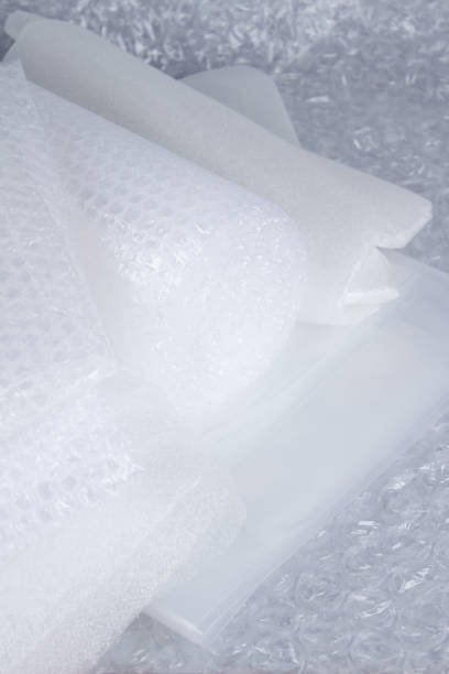 istock Set of plastic packaging materials - plastic stretch film rolls, foamed polyethylen sheets and rolls, different packaging films, small and large bubble pack rolls. Selective focus, vertical image 1329488446