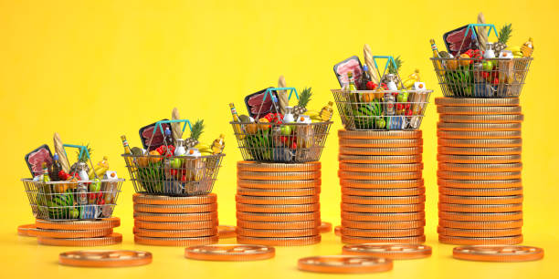 growth of food sales or growth of market basket or consumer price index concept. shopping basket with foods with coin stacks on yellow background. - munt culinair illustraties stockfoto's en -beelden