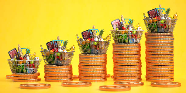 growth of food sales or growth of market basket or consumer price index concept. shopping basket with foods with coin stacks on yellow background. - inflation imagens e fotografias de stock