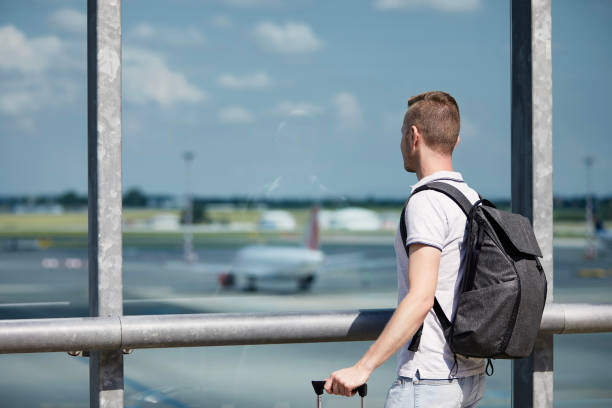 istock Traveler watching airplanes at airport 1329491648