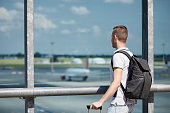 Traveler watching airplanes at airport