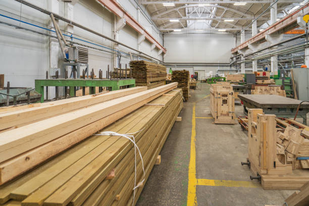 istock Typical woodworking factory interior, large workshop with automated machines and stacks of timber 1329491654