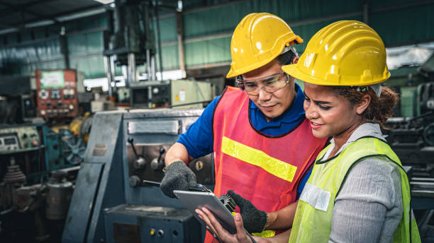 istock Two engineers discussing work together in the factory. 1329492018