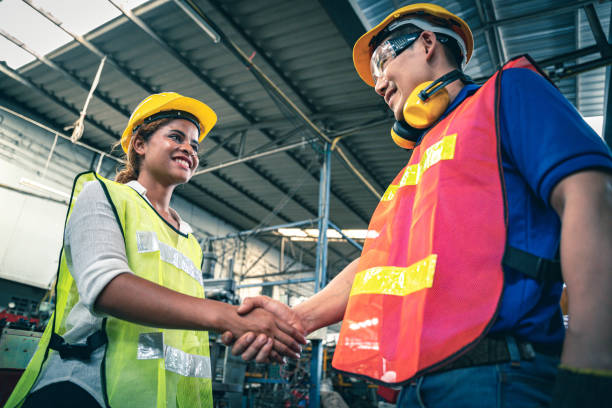 istock Female supervisor shaking hand with male engineer. 1329492019