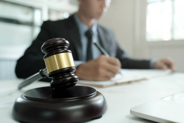istock Male lawyer in the office with brass scale. 1329493234