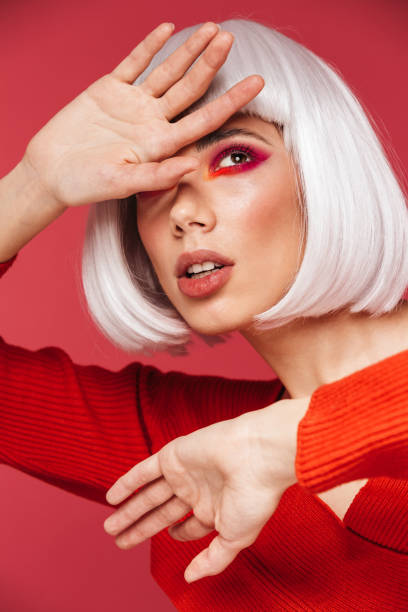 istock Beautiful young woman isolated over red wall background with bright makeup posing. 1329493457