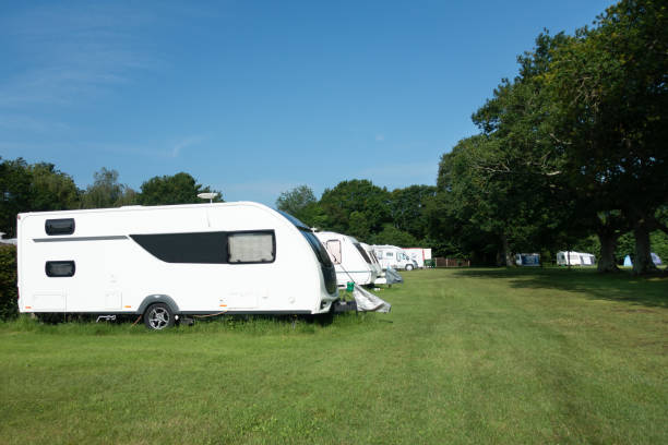 Rows of caravans on a rural caravan and camping park in rural England on a sunny summers day a perfect staycation spot during the Covid pandemic. stock photo
